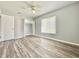 Bedroom with wood floors, closet, and window, featuring neutral walls and ceiling fan at 713 Wood Ln, Kissimmee, FL 34759