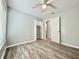 Bright bedroom with hardwood floors, neutral walls, ceiling fan, and closet at 713 Wood Ln, Kissimmee, FL 34759