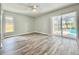 Bedroom features hardwood floors, neutral walls, natural light, and access to outdoor patio at 713 Wood Ln, Kissimmee, FL 34759
