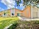 Inviting single-story home with lush landscaping, charming curb appeal, and a colorful front door at 713 Wood Ln, Kissimmee, FL 34759