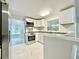 Modern kitchen with stainless steel appliances, bright white cabinets, and gray countertops for contemporary style at 713 Wood Ln, Kissimmee, FL 34759