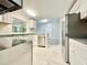 Renovated kitchen featuring stainless steel appliances, granite countertops, white cabinets and subway tile backsplash at 713 Wood Ln, Kissimmee, FL 34759