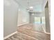 Bright living room with vaulted ceilings, modern ceiling fans, and beautiful wood-look flooring with pool view at 713 Wood Ln, Kissimmee, FL 34759