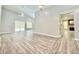 Spacious living room with views of pool, modern ceiling fans, and fireplace next to modern kitchen at 713 Wood Ln, Kissimmee, FL 34759