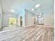 Open-concept living room featuring high ceilings, modern fans, and sliding glass doors at 713 Wood Ln, Kissimmee, FL 34759
