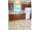 Functional kitchen equipped with wood cabinets, granite countertops, and modern appliances at 721 S Clyde S Ave, Kissimmee, FL 34741