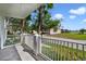 Relaxing balcony view featuring white railings and palm trees overlooking the community landscaping at 7468 Excitement Dr # 101, Reunion, FL 34747