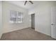 Bright bedroom featuring a window, closet, and neutral carpet, offering a cozy and inviting space at 7468 Excitement Dr # 101, Reunion, FL 34747