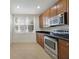Functional kitchen with stainless steel appliances, ample cabinets, and tile floor at 7468 Excitement Dr # 101, Reunion, FL 34747