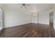 Spacious living area with a ceiling fan, wood floors, and natural light at 7468 Excitement Dr # 101, Reunion, FL 34747