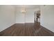 Open living area with gleaming wood floors and a view into the kitchen at 7468 Excitement Dr # 101, Reunion, FL 34747