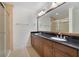 Modern main bathroom with double vanity, granite countertops and separate glass shower at 7468 Excitement Dr # 101, Reunion, FL 34747