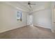 Bright main bedroom with large window, ceiling fan and access to an outdoor balcony at 7468 Excitement Dr # 101, Reunion, FL 34747