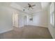 Spacious main bedroom featuring neutral tones, a ceiling fan, and plenty of natural light at 7468 Excitement Dr # 101, Reunion, FL 34747