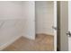 Well-organized walk-in closet with built-in shelving, offering ample storage space at 7468 Excitement Dr # 101, Reunion, FL 34747