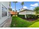 This backyard features a lawn, bushes, and view of neighboring homes at 7740 Linkside Loop, Reunion, FL 34747