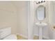 Powder room featuring a pedestal sink and tile flooring, perfect for guests at 7740 Linkside Loop, Reunion, FL 34747
