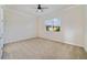This bedroom features a ceiling fan, window, and neutral carpet at 7740 Linkside Loop, Reunion, FL 34747