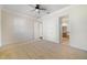 This bedroom features an ensuite bathroom, neutral carpet, and white trim at 7740 Linkside Loop, Reunion, FL 34747