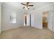 Large bedroom with a ceiling fan, double closets and an attached bathroom at 7740 Linkside Loop, Reunion, FL 34747