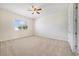 This bedroom features a ceiling fan, window, and neutral carpet at 7740 Linkside Loop, Reunion, FL 34747