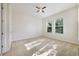 Bright bedroom featuring two large windows and neutral carpet at 7740 Linkside Loop, Reunion, FL 34747