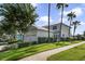 Charming two-story home with a well-manicured lawn, complemented by lush palm trees in a desirable neighborhood at 7740 Linkside Loop, Reunion, FL 34747