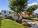 This front yard features a lawn, driveway, and landscaping at 7740 Linkside Loop, Reunion, FL 34747