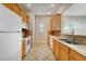 Well-lit kitchen featuring wood cabinets, tile backsplash, and modern appliances at 7740 Linkside Loop, Reunion, FL 34747