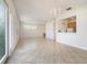 Open-concept living room flows into kitchen with tile floors and a view to the backyard at 7740 Linkside Loop, Reunion, FL 34747