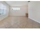 Spacious living room with tile flooring, bright natural light, and a built-in desk at 7740 Linkside Loop, Reunion, FL 34747