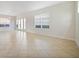Bright and airy living room with large windows and tile flooring throughout the space at 7740 Linkside Loop, Reunion, FL 34747