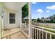Picturesque view from the porch showcasing the lake and community clubhouse on a sunny day at 7740 Linkside Loop, Reunion, FL 34747