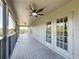 A screened balcony complete with fan offers relaxing outdoor space and access to the indoors through bright, glass doors at 805 Suffolk Pl, Davenport, FL 33896