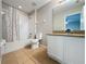 Bathroom features a shower-tub combo, tile flooring, toilet, and vanity, providing a functional and stylish space at 805 Suffolk Pl, Davenport, FL 33896