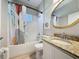 Bathroom includes a shower-tub combo and granite countertop sink at 805 Suffolk Pl, Davenport, FL 33896