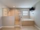 Modern bathroom boasting a glass shower, soaking tub and recessed lighting for a spa-like experience at 805 Suffolk Pl, Davenport, FL 33896
