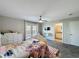 Bedroom features a ceiling fan and carpet flooring, leading to the bathroom, offering comfort and convenience at 805 Suffolk Pl, Davenport, FL 33896