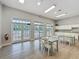 Bright dining area next to the community pool with tables, chairs, and a kitchenette at 805 Suffolk Pl, Davenport, FL 33896