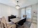 Formal dining room with chandelier, large wooden table, and ample seating at 805 Suffolk Pl, Davenport, FL 33896