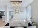 Elegant entryway with modern chandelier, neutral paint, and view into the kitchen at 805 Suffolk Pl, Davenport, FL 33896