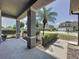 Charming front porch with shade from a palm tree, decorative landscaping, and a clear view of the neighborhood at 805 Suffolk Pl, Davenport, FL 33896