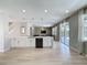 Open concept kitchen with white cabinets, stainless steel appliances, and a spacious island with seating at 805 Suffolk Pl, Davenport, FL 33896