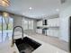 Bright kitchen featuring white cabinetry, stainless appliances, an island sink, and stylish fixtures at 805 Suffolk Pl, Davenport, FL 33896