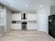 Bright kitchen featuring white cabinetry, modern appliances, and lots of counter space at 805 Suffolk Pl, Davenport, FL 33896