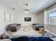 Bright living room featuring modern furniture, a large screen TV, and a stylish chandelier at 805 Suffolk Pl, Davenport, FL 33896