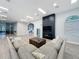 Expansive lounge area showcases a large sectional sofa, chic decor, and welcoming ambiance for gatherings at 805 Suffolk Pl, Davenport, FL 33896