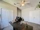 Home office space with a closet, multiple doors, and a large desk at 805 Suffolk Pl, Davenport, FL 33896