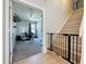 View of the carpeted home office with a ceiling fan and white board, located near the stairs and a safety gate at 805 Suffolk Pl, Davenport, FL 33896