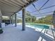 Relaxing screened-in pool area with lounge chairs, outdoor grill, and well-maintained patio, perfect for entertaining at 805 Suffolk Pl, Davenport, FL 33896